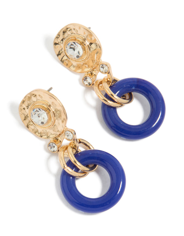 Showcasing statement earrings in gold with dark blue acrylic circle drop design front view
