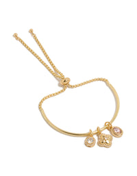 Beautifully crafted gold plated cubic zirconia and flower charms toggle bangle with oval stone and crystal accents front view - link has visual effect only