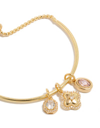 Elegantly designed gold plated cubic zirconia and flower charms toggle bangle featuring oval stone with crystal details close up view - link has visual effect only