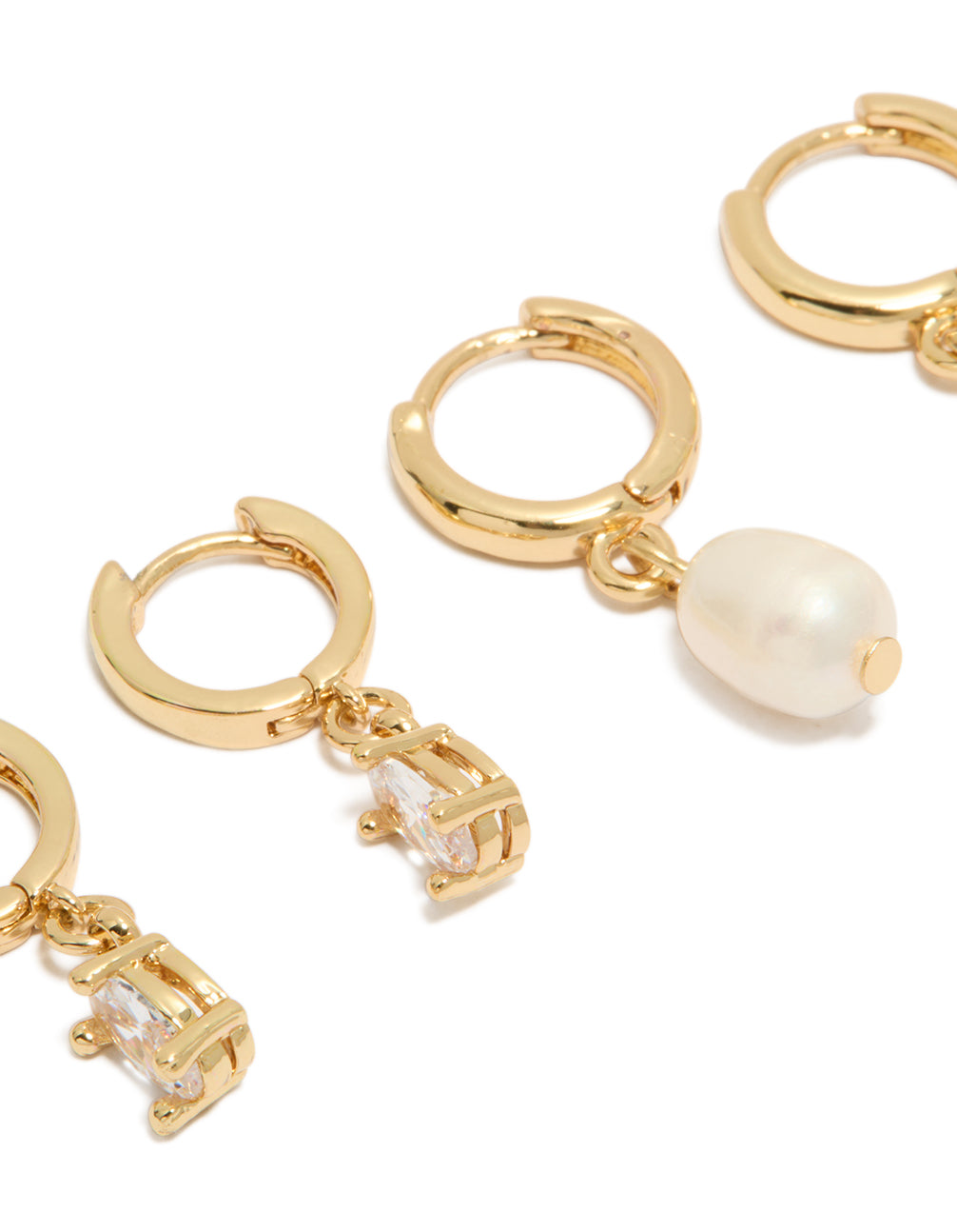 Crafted from gold plated materials, these cubic zirconia and pearl huggie earrings in a 2-pack with crystal features close up view