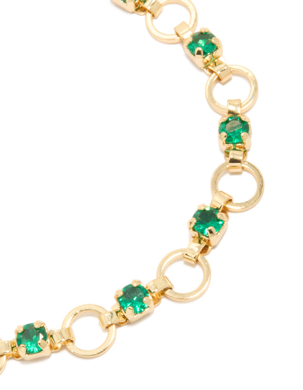 Explore the intricate details of this gold plated link bracelet with alternating round green cubic zirconia close up view