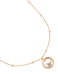 Elegant butterfly in circle pendant necklace featuring balls, pearl and gold accents close up view - link has visual effect only