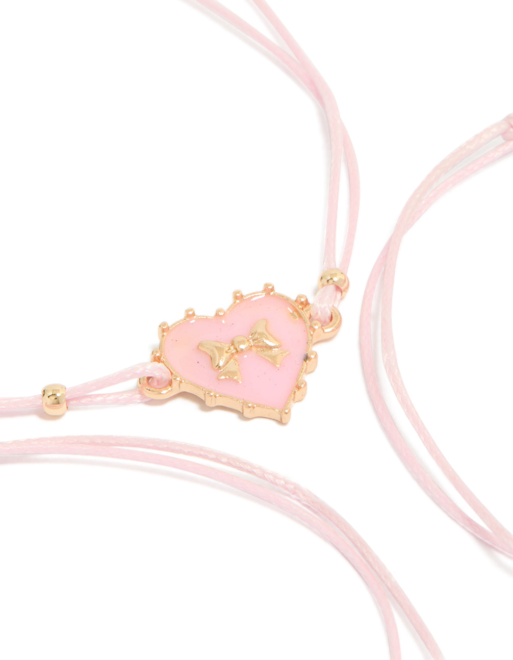 Showcasing heart charm bracelets crafted from cord and enamel in a 3-pack with light pink and gold tones close up view