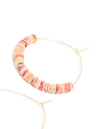 Displaying large hoop earrings with beaded genuine pink shells and statement style in gold post detail view - link has visual effect only