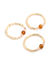 Featuring beaded resin stretch bracelets in a 3-pack with gold and brown tones front view - link has visual effect only