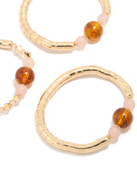 Showcasing beaded resin stretch bracelets in a 3-pack with gold and brown tones close up view - link has visual effect only
