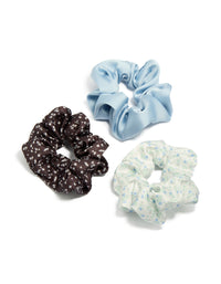 Featuring a floral print, this brown and blue mixed fabric scrunchies 3-pack in light blue, ivory, and powder blue tones front view - link has visual effect only