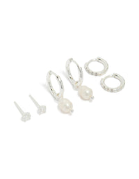 Showcasing a stainless steel cubic zirconia and freshwater pearl huggie and stud earrings pack featuring crystal in waterproof silver and ivory front view - link has visual effect only