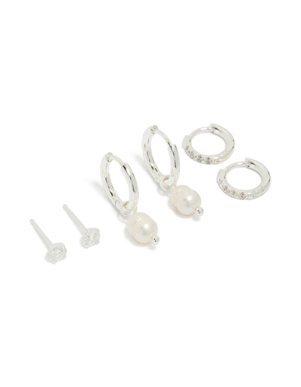 Showcasing a stainless steel cubic zirconia and freshwater pearl huggie and stud earrings pack featuring crystal in waterproof silver and ivory front view