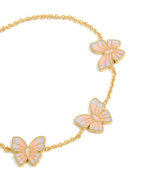 Featuring a tweens butterfly charm bracelet with glitter enamel accents, crafted from waterproof gold plated stainless steel in pink and lavender close up view - link has visual effect only