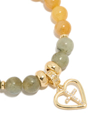 Featuring a gold plated beaded bracelet with cross and heart in cubic zirconia, chunky statement design close up view - link has visual effect only