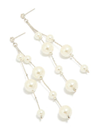 Showcasing silver pearl drop earrings in white front view - link has visual effect only