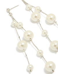 Elegant silver pearl drop earrings in white close up view - link has visual effect only