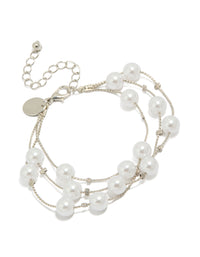Showcasing a silver pearl layered bracelet with in white front view - link has visual effect only