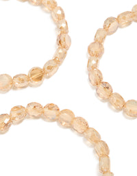 Highlighting amber beaded stretch bracelets in a 3-pack with wheat and burlywood tones close up view - link has visual effect only