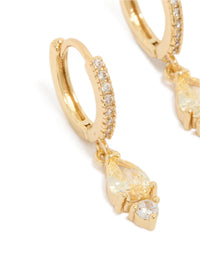 Featuring gold plated cubic zirconia huggie earrings with huggie closure in yellow close up view - link has visual effect only