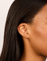 Discover dainty vine design flat back stud earrings crafted from gold plated surgical steel featuring marquise cut cubic zirconia stones on ear view - link has visual effect only