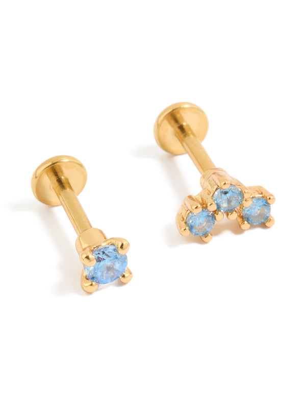 Showcasing gold plated titanium flat back studs featuring blue cubic zirconia crystals front view