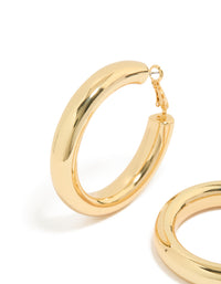 Featuring gold plated thick hoop earrings with chunky design close up view - link has visual effect only