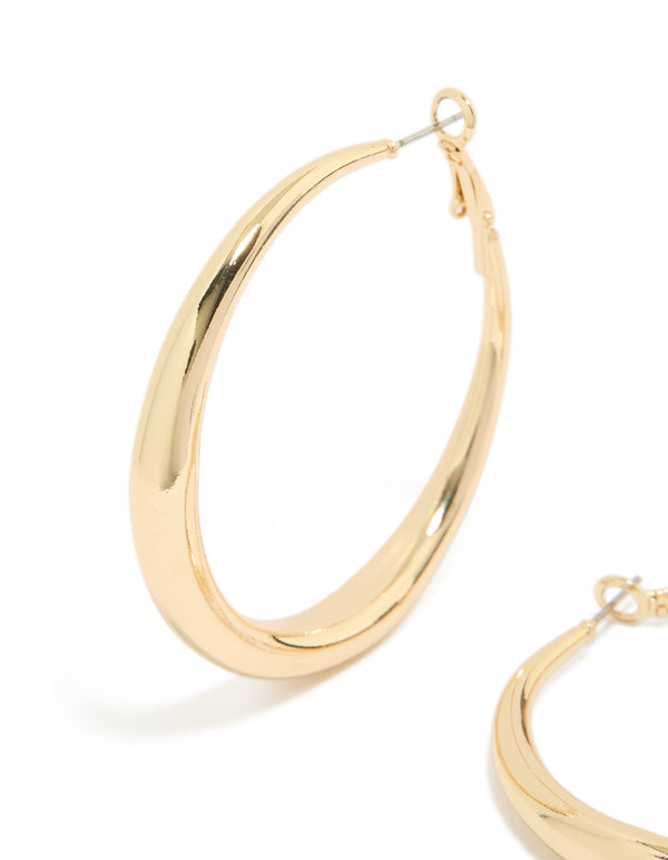 Featuring medium hoop earrings crafted from gold plated material with hoop closure close up view