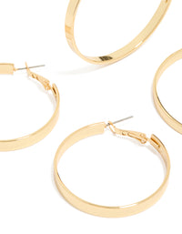 Showcasing wide flat hoop earrings in a 2-pack, crafted from gold plated material with statement styling and hoop closure close up view - link has visual effect only