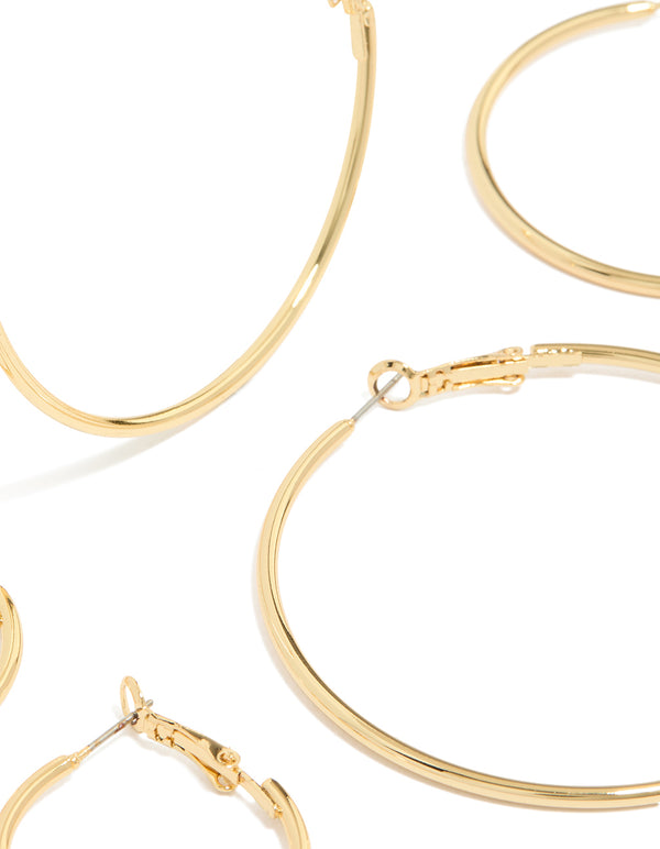 Showcasing gold plated small and medium hoop earrings with closure detail in a 3-pack close up view