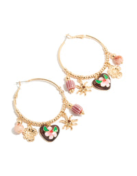 Showcasing gold brown heart and sun charm hoop earrings featuring floral beads, celestial design and striped pattern in front view - link has visual effect only