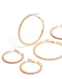 Featuring gold clear and pink diamante mixed size hoop earrings in a 3-pack close up view - link has visual effect only