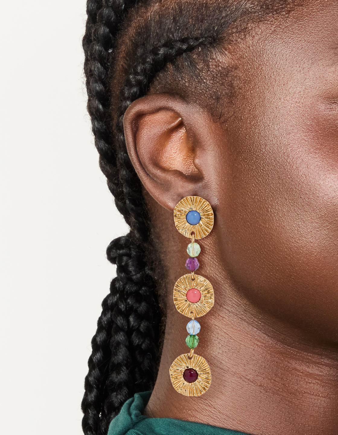 Showcasing gold round disc and multicoloured bead drop earrings with statement style on ear view