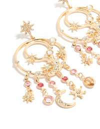 Crafted from gold with pink and clear diamantes celestial charm accents, these statement circle drop earrings display star motifs and stud closures in close up view - link has visual effect only