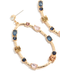 Featuring statement earrings in an oval stone cut with blue, pink, and clear diamantes set in a gold open drop design close up view - link has visual effect only