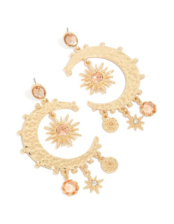 Showcasing gold clear and pink diamante celestial moon drop earrings with charm and disc details front view