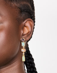 Crafted from gold, these irregular shaped purple and blue diamantes drop earrings in statement style on ear view - link has visual effect only