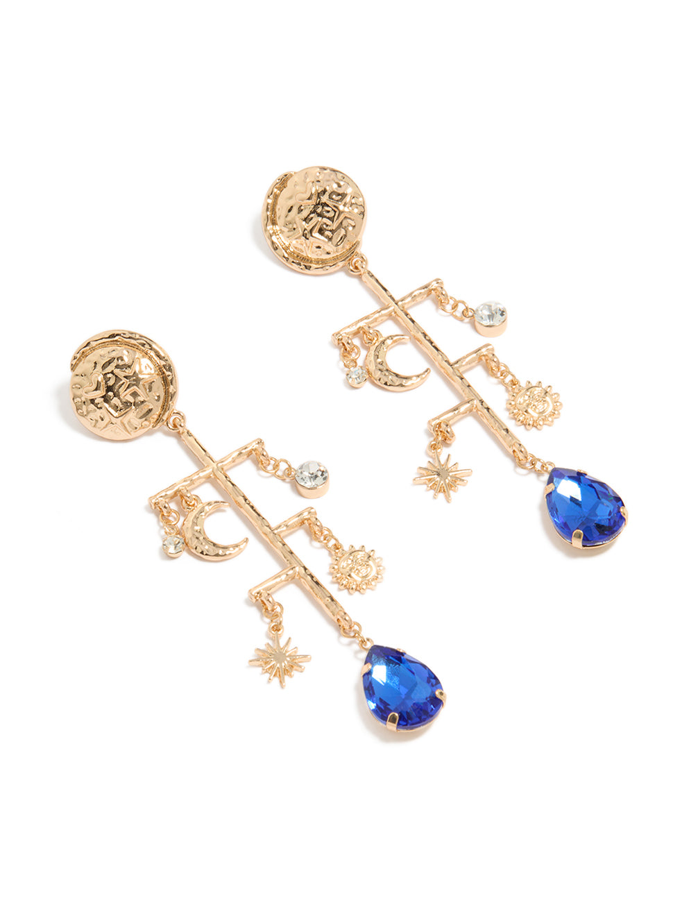 Showcasing statement drop earrings in worn gold featuring celestial charms with moon, sun, star details, marble pattern accents, and royal blue teardrop gemstone front view