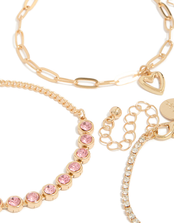 Explore the fine details of gold diamantes and heart charm bracelet 4-pack with beads in light pink, powder blue, and clear stone close up view