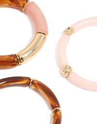 Featuring a beaded charm stretch bracelet 3-pack crafted from resin in pink and gold close up view - link has visual effect only