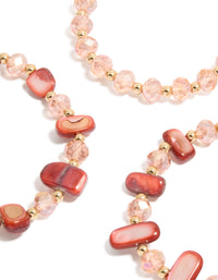 Discover beaded stretch bracelets with shell accents in light coral, light pink, and gold as a 3-pack close up view - link has visual effect only