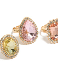 Featuring gold pink and purple pastel diamante rings in a 3-pack with halo and oval stone cut designed for statement style close up view - link has visual effect only