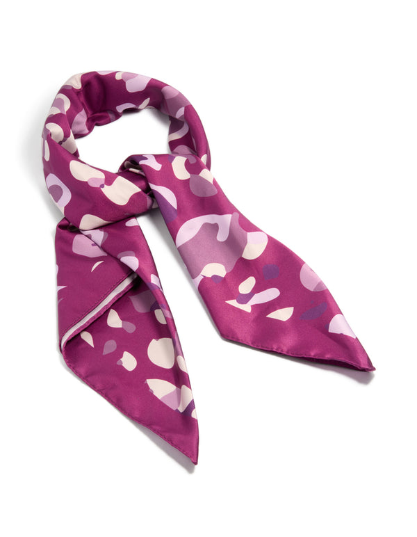 Showcasing a berry pink fabric scarf scrunchie with leopard print in maroon, light pink, medium orchid, and bisque tones detail view