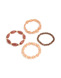 Showcasing a 4-pack of pink and brown beaded stretch bracelets in gold front view - link has visual effect only