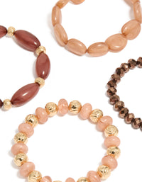 Displaying beaded stretch bracelets in pink and brown close up view - link has visual effect only