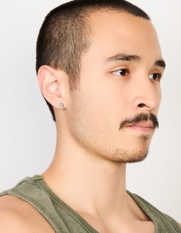 Highlighting mens waterproof stainless steel round flat back stud earrings in silver and black on model view