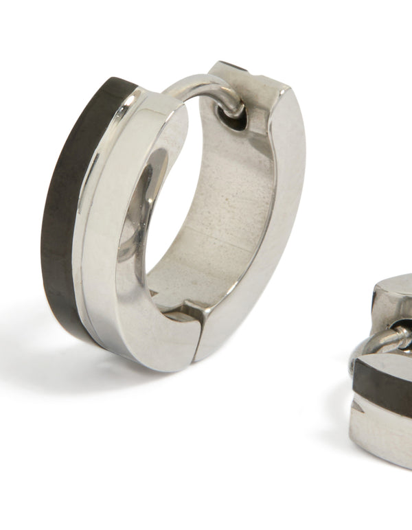 Highlighting the waterproof stainless steel construction with black enamel inlay on statement huggie earrings close up view