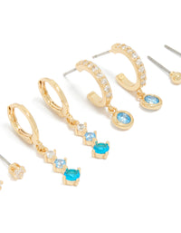 Showcasing gold plated clear and light blue cubic zirconia stacker earrings 4-pack with crystal details in huggie and stud styles close up view - link has visual effect only