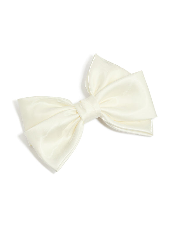 Featuring a bow solid ivory statement clip front view