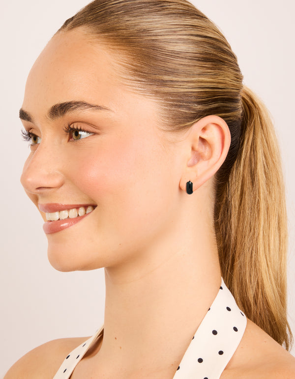 Designed with waterproof black coated stainless steel, these chunky huggie earrings on model view
