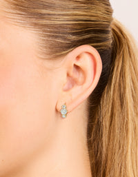 Featuring dainty trio mini huggie earrings in waterproof gold plated stainless steel with cubic zirconia on ear view - link has visual effect only
