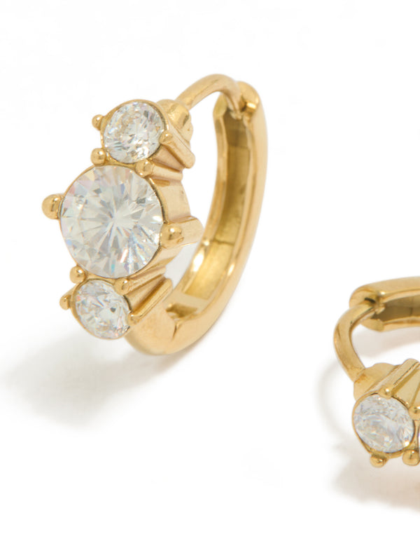 Highlighting dainty trio mini huggie earrings in waterproof gold plated stainless steel with cubic zirconia close up view