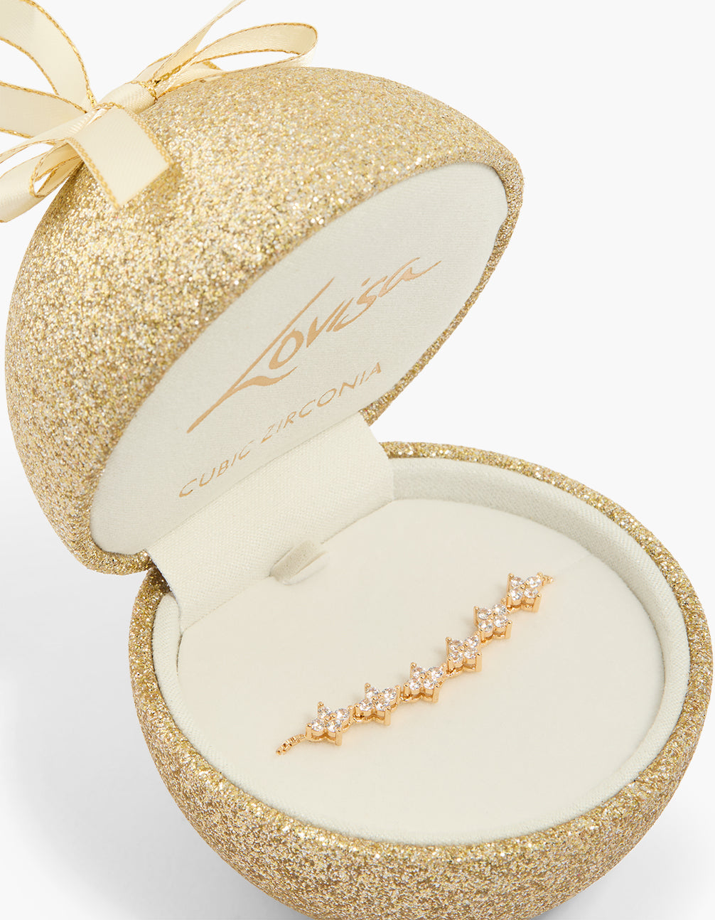 Beautifully crafted cubic zirconia flower tennis toggle bracelet in gold, showcased in a glitter gift box close up view
