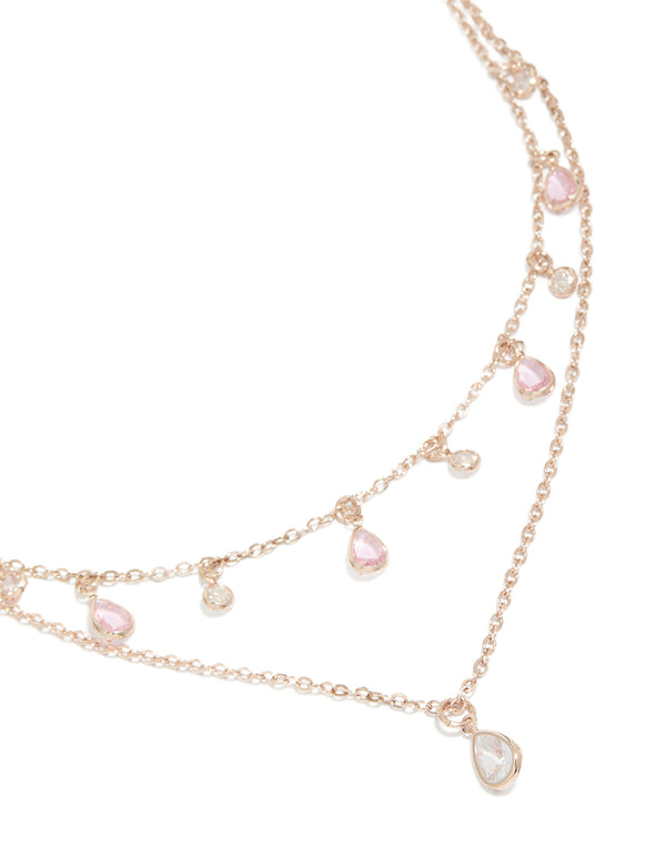 Showcasing a layered necklace with charm featuring pear stone pink and clear cubic zirconia in rose gold plated finish close up view